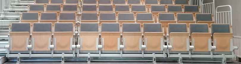 Telescopic tribunes with upholstered spring-folded seats