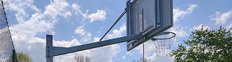 Baskets mounted on post structures for outdoor basketball courts